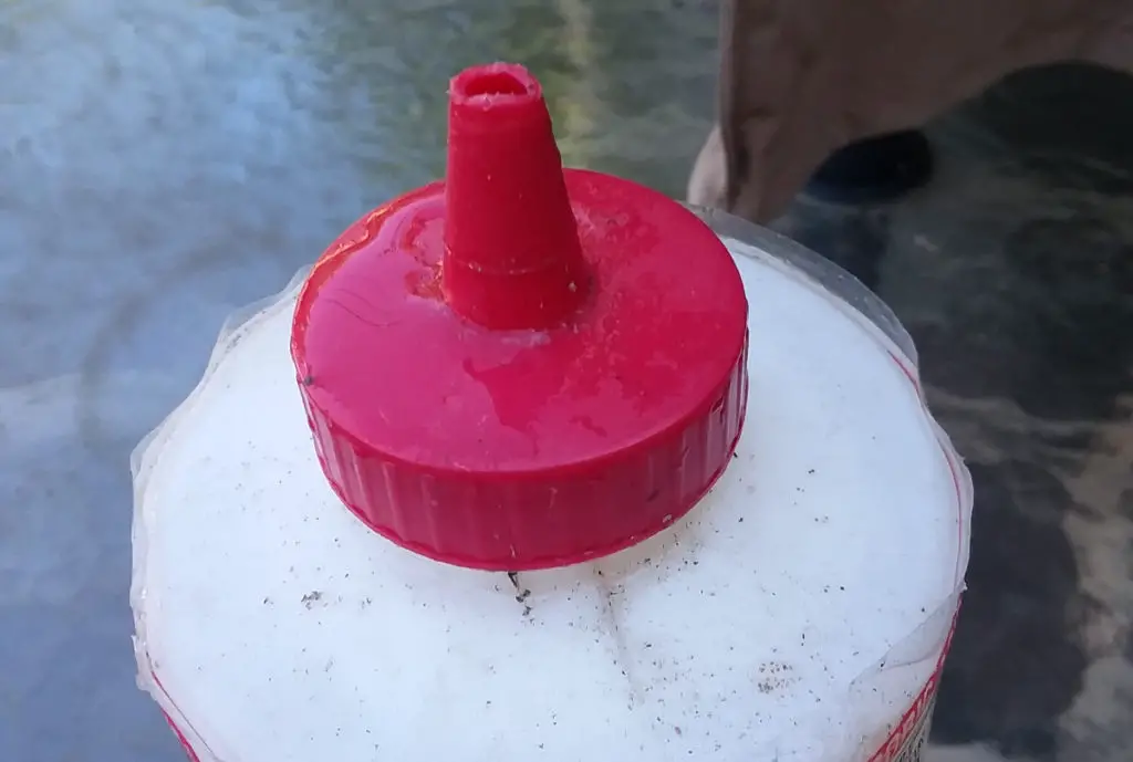 Top of a bottle for getting natural weed killer into cracks.