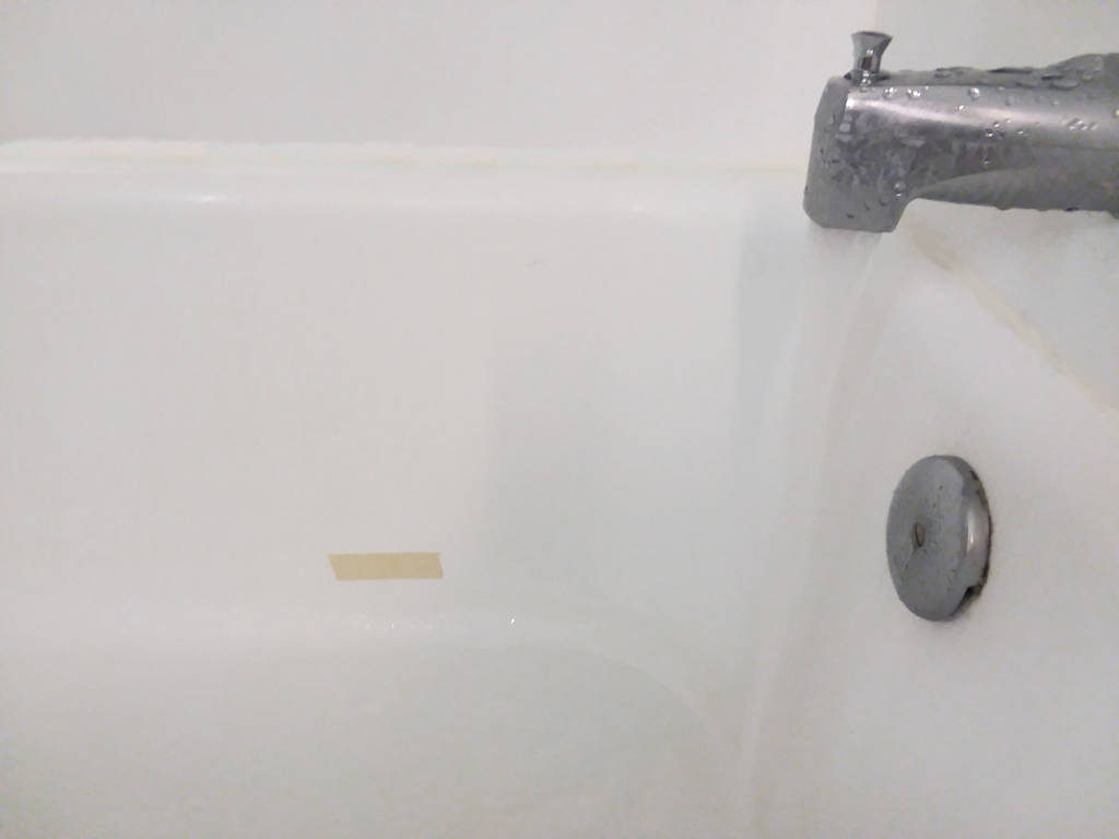 Filling bathtub to tape line.