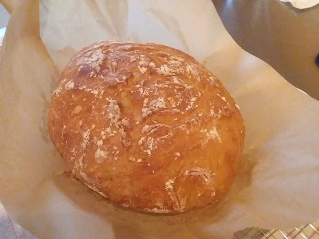 Homemade baked bread on parchment paper.