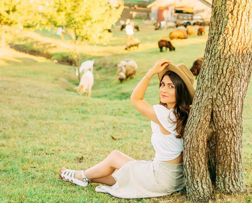 Woman on hillside with farm animals