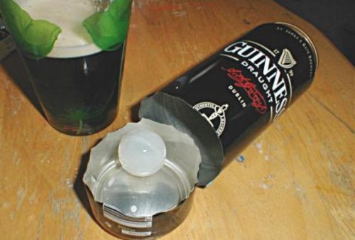 Can of Guinness cut open with plastic widget inside.